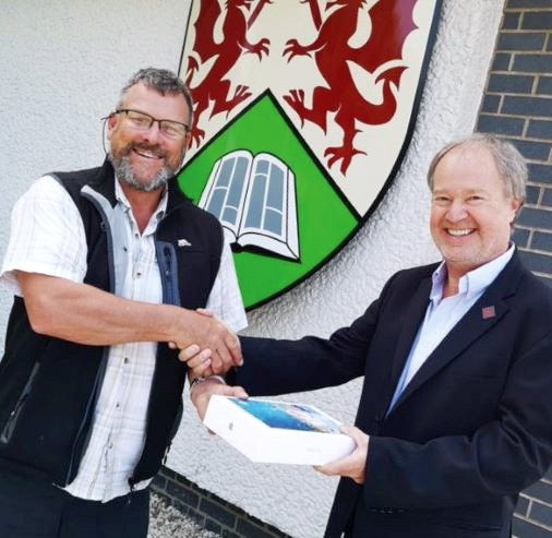 Professor Bryn Hubbard receiving the winning prize of an iPad from Gavin Rowlands, our Business Development Manager.
